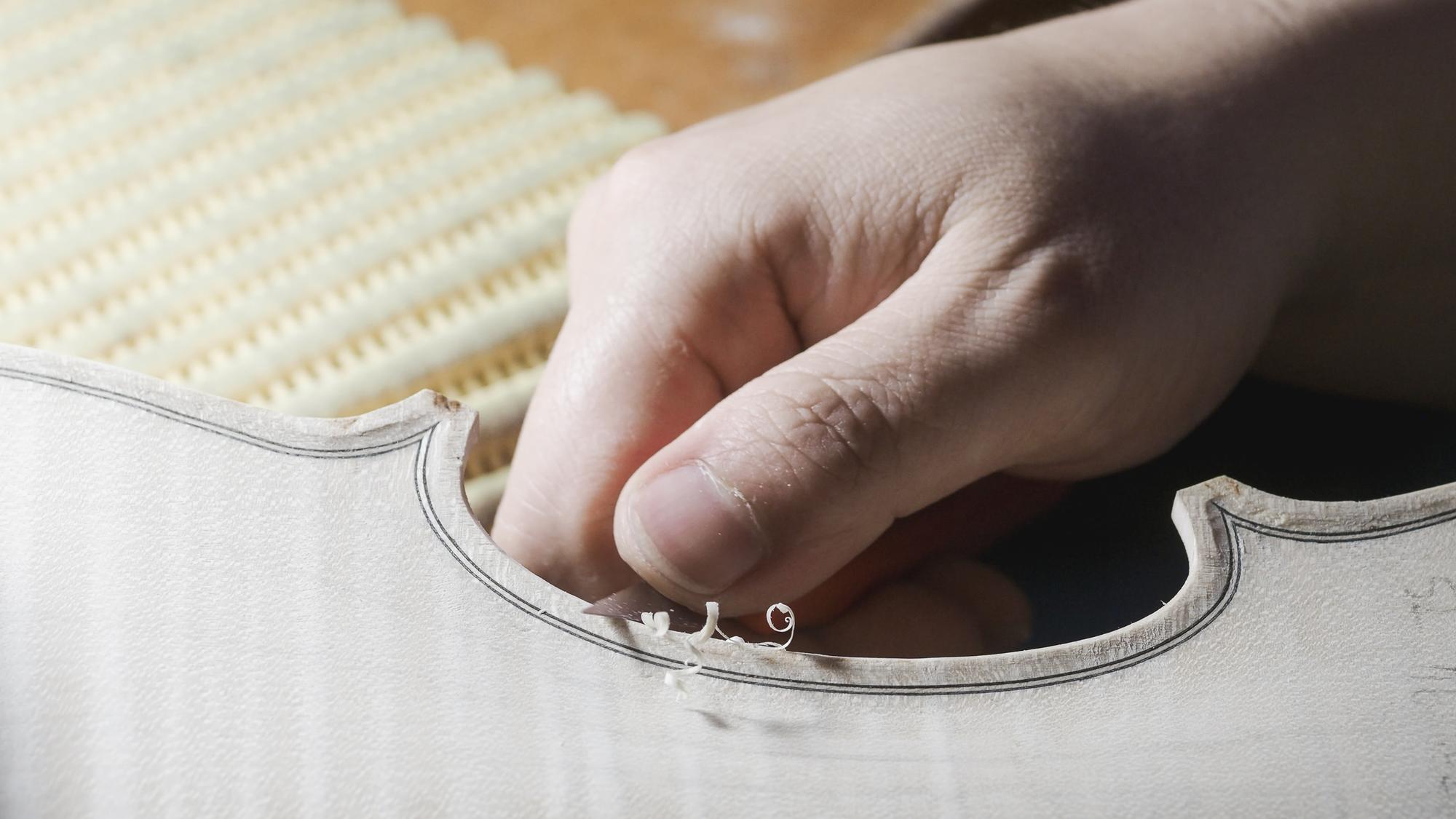 Artisan hand finishing embroidered patch