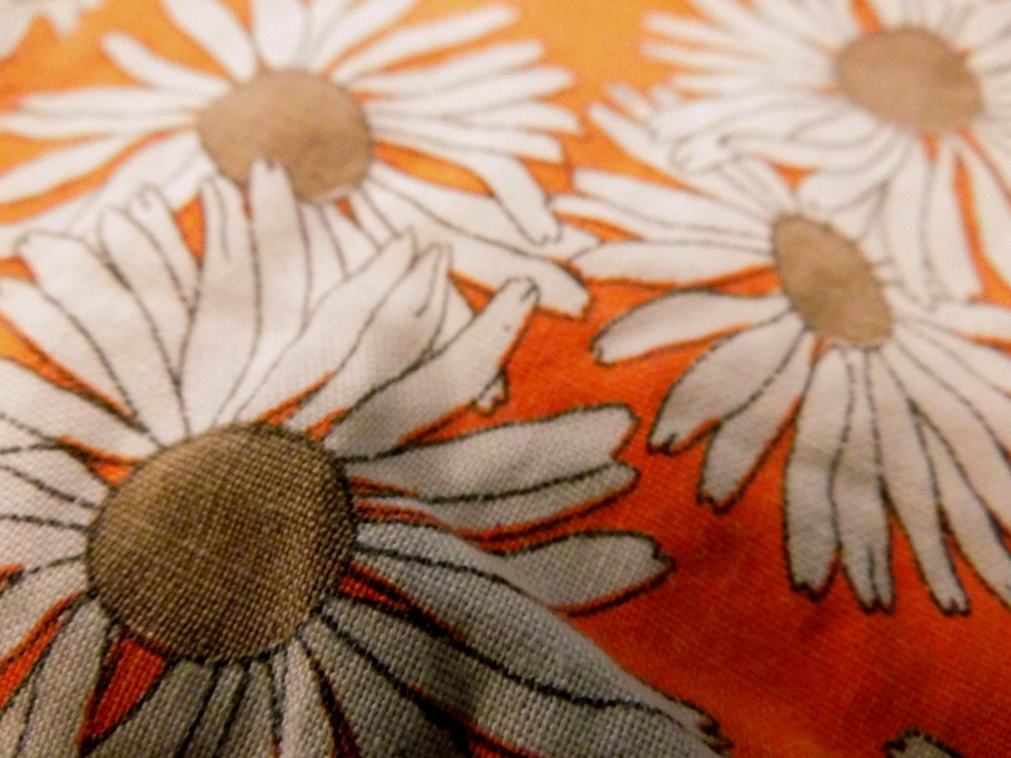 Close-up of multicolor embroidered floral patch on linen